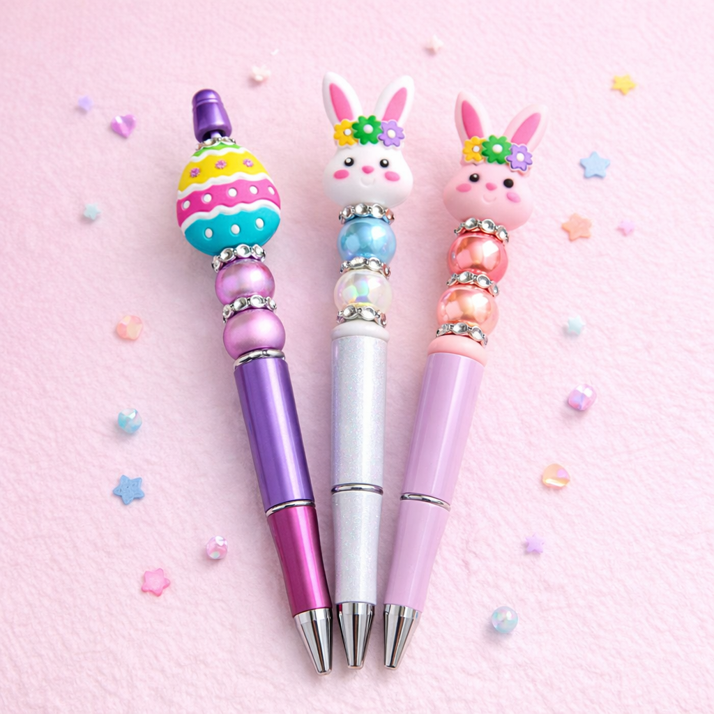 Three colorful pens with rabbit-shaped ends on a pink background
