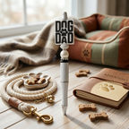 Pen with 'Dog Dad' sign, leash, and dog treats on a wooden surface.