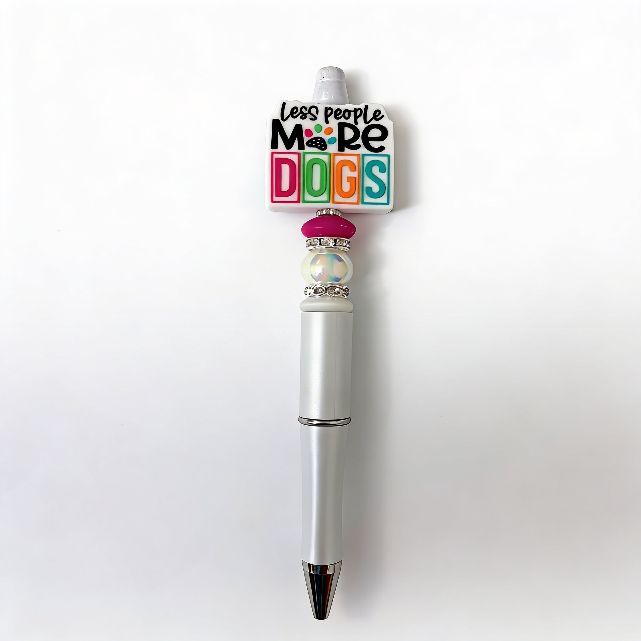 Pen with a colorful 'Less people, More dogs' clip on a white background