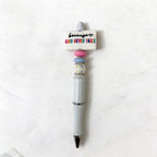 Pen with decorative top on a white background