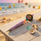 Colorful pen and decorative items on a wooden surface with a beach background