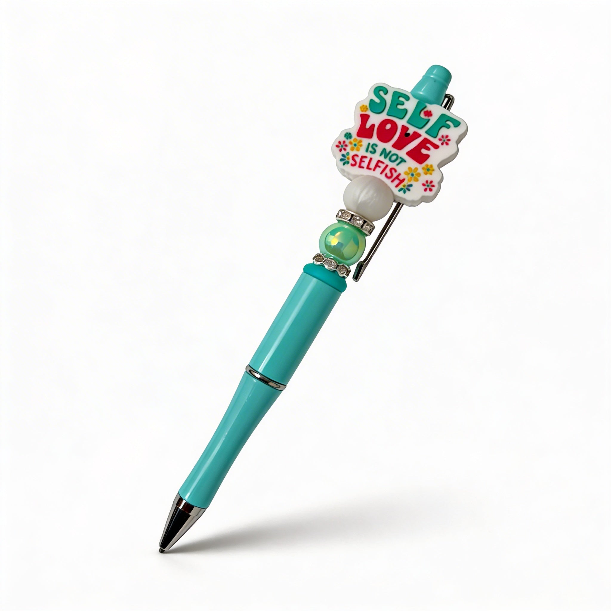 Turquoise pen with colorful heart-shaped clip on a white background