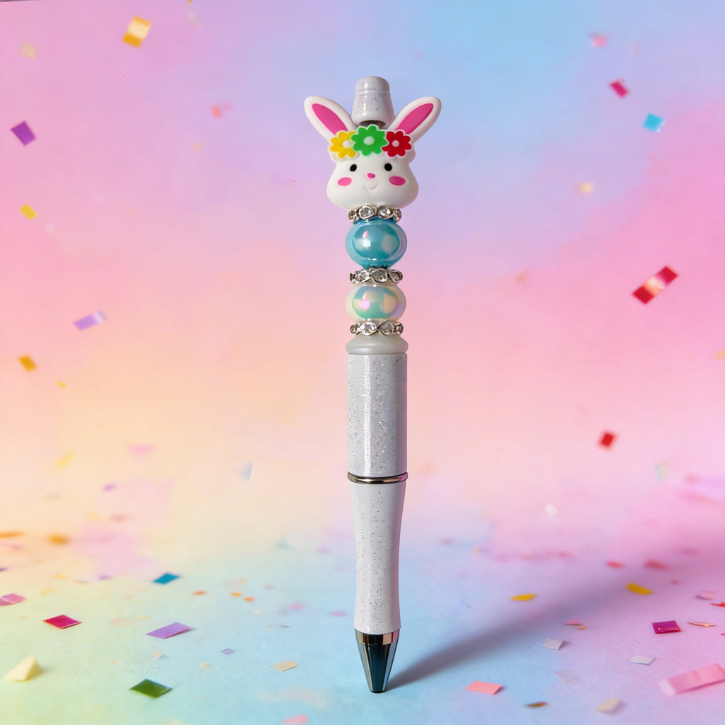 Decorative pen with rabbit design on a colorful confetti background