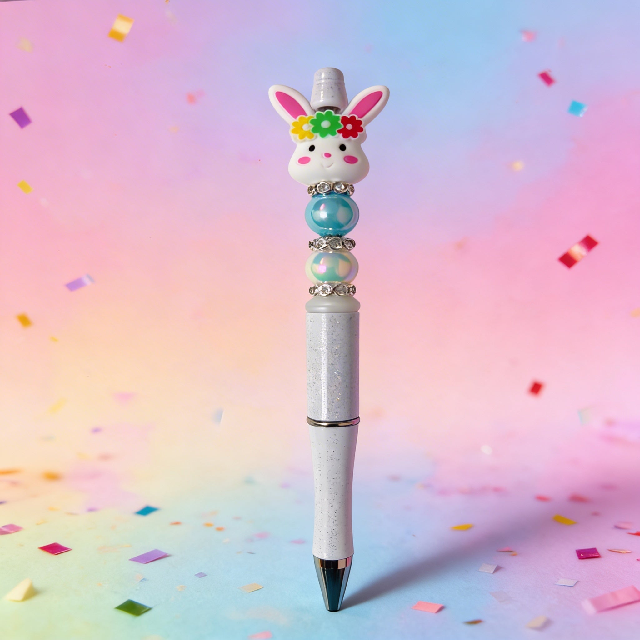 Decorative pen with rabbit design on a colorful confetti background