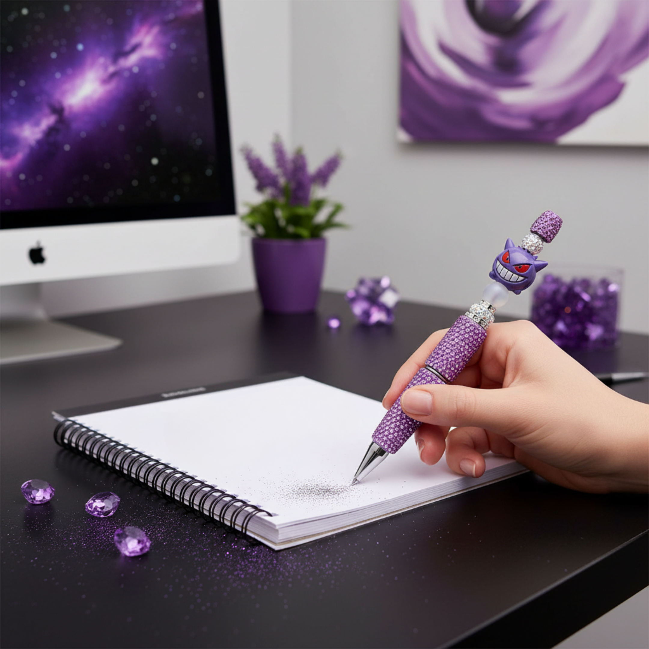 Hand writing with purple rhinestone decorative monster pen on notebook