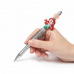 Hand holding cute mermaid rhinestone decorative pen for writing